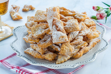 Traditional Italian carnival fritters dusted with icing sugar - frappe or chiacchiere