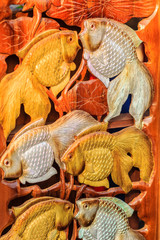Beautiful Wood carving of gold silver fishes. Antique Art Handmade Furniture which Carvings gold silver fishes in The Wood. Gold silver fishes wooden crafted for sale in market at Northern Thailand.
