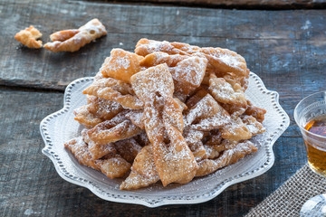 Traditional Italian carnival fritters dusted with icing sugar - frappe or chiacchiere