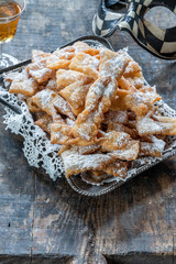 Traditional Italian carnival fritters dusted with icing sugar - frappe or chiacchiere - obrazy, fototapety, plakaty