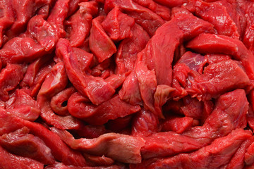 Raw veal pieces background.  Beef stroganoff.