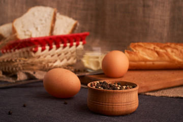 Different bread and wheat on the rustic table. Selective focus, close up