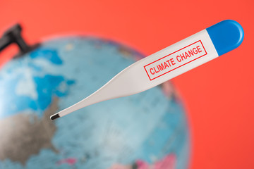 Sick earth with digital electronic thermometer. Medical thermometer climate change inscription....