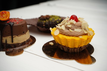 Beautiful designer chocolate cake stands on the table. Delicious good looking home-made desserts by chef.