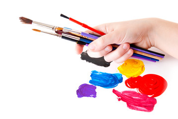 Colored paint and hand with tassels on a white background
