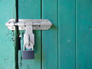 locked key on aged light pastel blue color wood wall background.