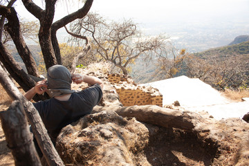 Man covering his head with a bandana at the bottom of a pyramid dating from 1153 buried in the...