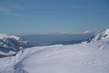 Obraz premium View of the mountains around the Tonale Pass from the Paradiso lodge during a winter sunny day. Tonale is a mountain pass between Lombardy and Trentino, near the Presena glacier