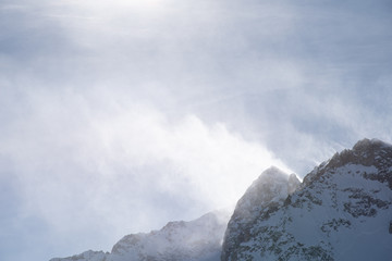 View of the mountains around the Tonale Pass from the Paradiso lodge during a winter sunny day. Tonale is a mountain pass between Lombardy and Trentino, near the Presena glacier