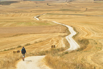 Young man is walking on the Cammino de Santiago de Compostela.