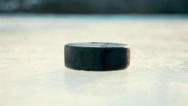 The approach of the black hockey puck on the ice 1080p