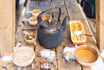 Picnic with tea in kettle and pie in cold winter day, Finland