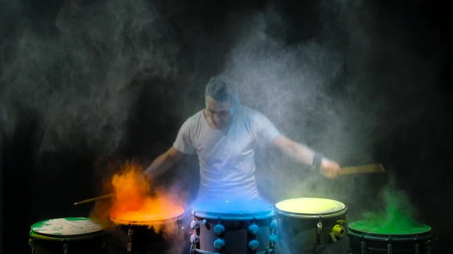 Drummer playing the drum holi powder