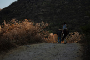 Men, women and horses doing trekking on a large hill of the speaker in a state of Mexico