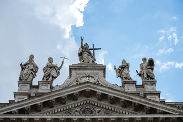 Fototapeta na wymiar Rome, Italy May 13, 2016: Statues of Christ and some saints on the top of Saint John Lateran Basilica facade.