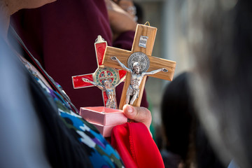 Vatican City, April 12, 2017: A woman holds Jesus Christ cross