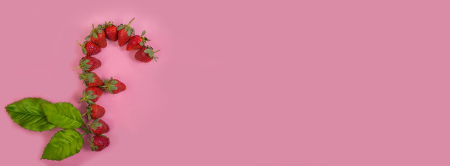 F letter made of strawberries on pink background