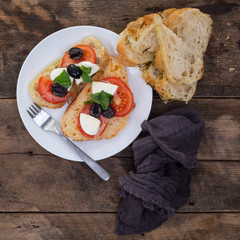 Tomato,  mozzarella, basil and olive salad on Rosemary & rock salt Focaccia bread