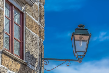 Fototapeta na wymiar View of a public classic street lamp on exterior wall house