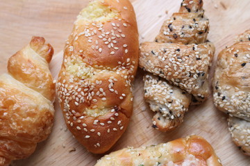 Bread and croissant on wooden table