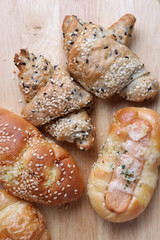 Bread and croissant on wooden table