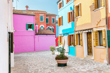 Colorful houses on the street in Burano island, near Venice. Tourism and vacation in Italy concept