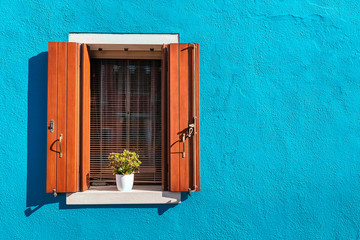 Picturesque window in blue colorful house as design concept