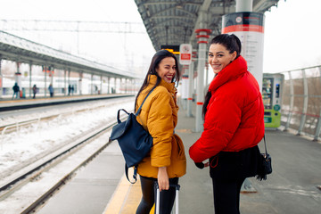 Two girlfriends going to trip by railway train