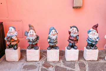 funny garden dwarf against door in a village or town