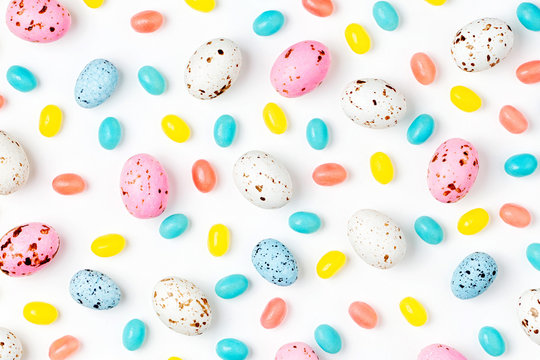 Pattern  Made Of Easter Candy Chocolate Eggs And Jellybean On White Background