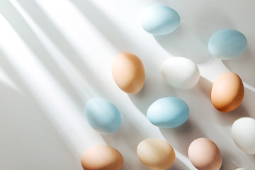 Natural Colored Eggs with sunlights. Compositions in pastel colors. Easter consept.  Flat lay, top view