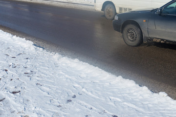 car drives in the winter on a dirty road