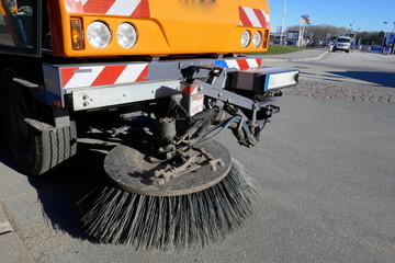  Special vehicle of the city cleaning sweeps the road with rotary brooms