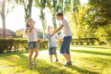 Naklejka na ściany i meble happy children play on the lawn