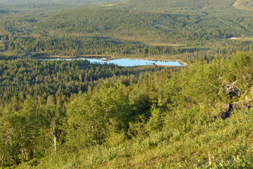 Fototapeta na wymiar Blue Lake in northern hills of Finnish Lapland