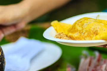 Close up hand of vendor during cooking for the original Thai Fried Noodle(Pad Mee Boran), stir-fried noodle with shrimp and egg commonly served as a street food popular in Thailand