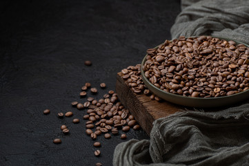 Roasted coffee beans on a dark background. Photo with negative space.
