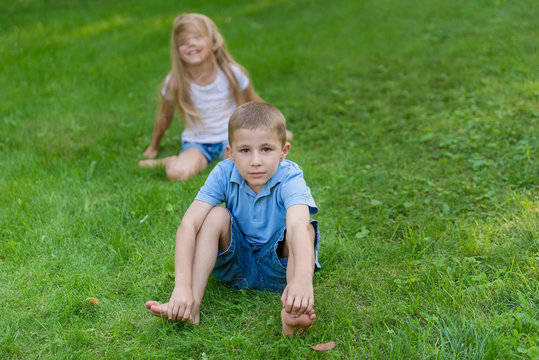 Boy and girl play on the grass