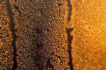 water drops on the glass surface at sunset, macro