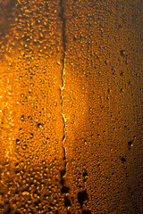 water drops on the glass surface at sunset, macro