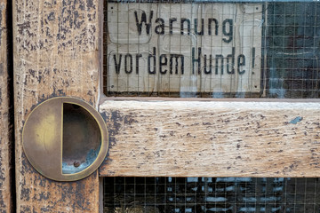 old sign on a door with the text 
