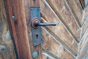 very wooden door with pattern very old worn out with iron door handle