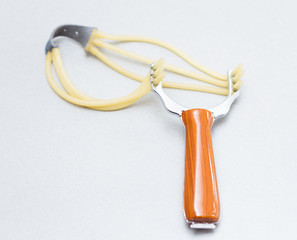 slingshot made of wood and steel on a white background