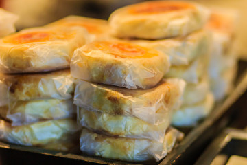 Moon cake or Chinese ancient dessert called 'Pia',ancient dessert Made from flour to Baking heat Mashed golden beans stuffed with salted egg yolk,Chinese pastry or moon cake.