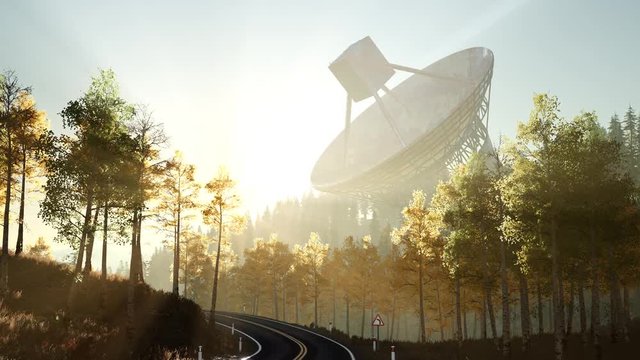 The observatory radio telescope in forest at sunset