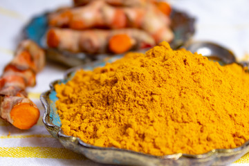 Fresh turmeric or curcuma root and dried powder, wildly used in Asia and India as spice, food...