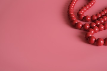 Red beads isolated on pink background
