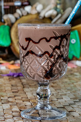 Chocolate frappe with whipped cream, syrup and cookies.