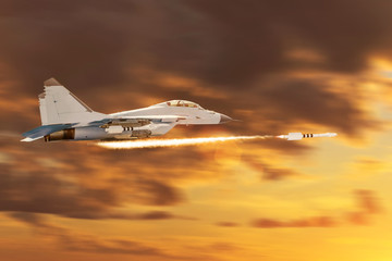Combat fighter jet flies high speed launches missiles at target. Conflict, war. Aerospace forces. Orange sky sunset.