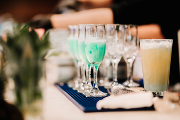 close up details of blue curacao tropical and exotic cocktails. Professional bartender mixing and preparing drinks